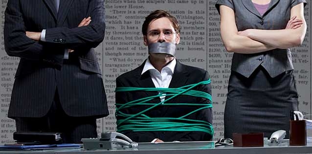 Illustration of man tied up in in front of a desk with tape over his mouth.