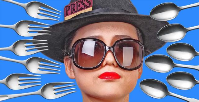 Student journalist surrounded by forks and knives